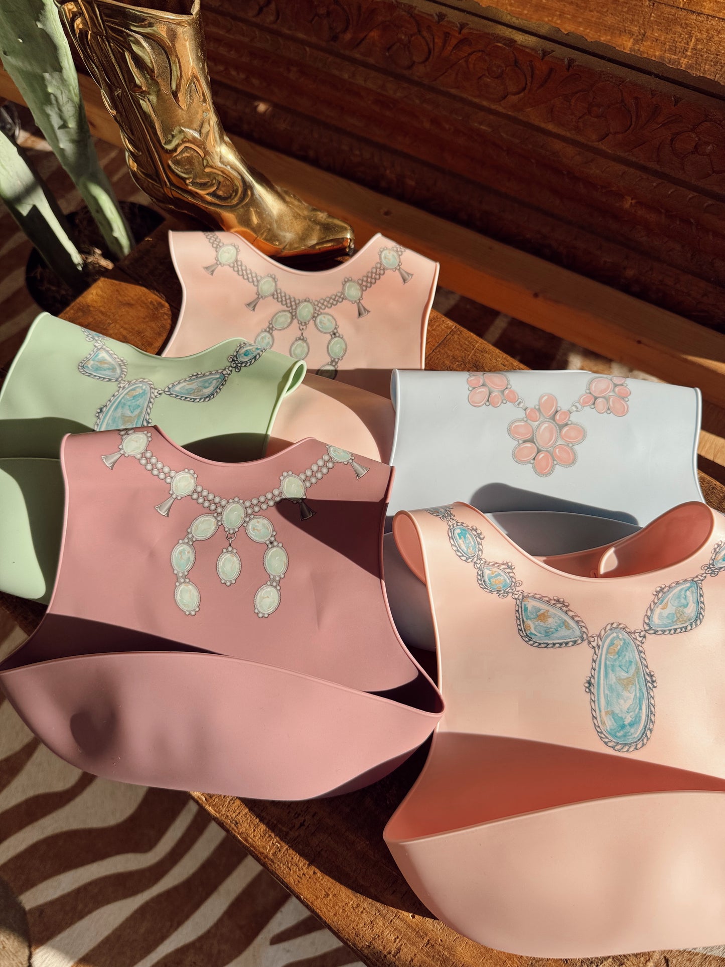 The Turquoise Squash Silicone Bib in Pink