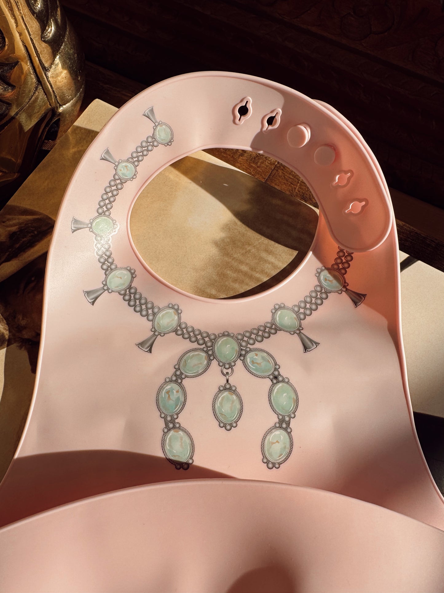The Turquoise Squash Silicone Bib in Pink