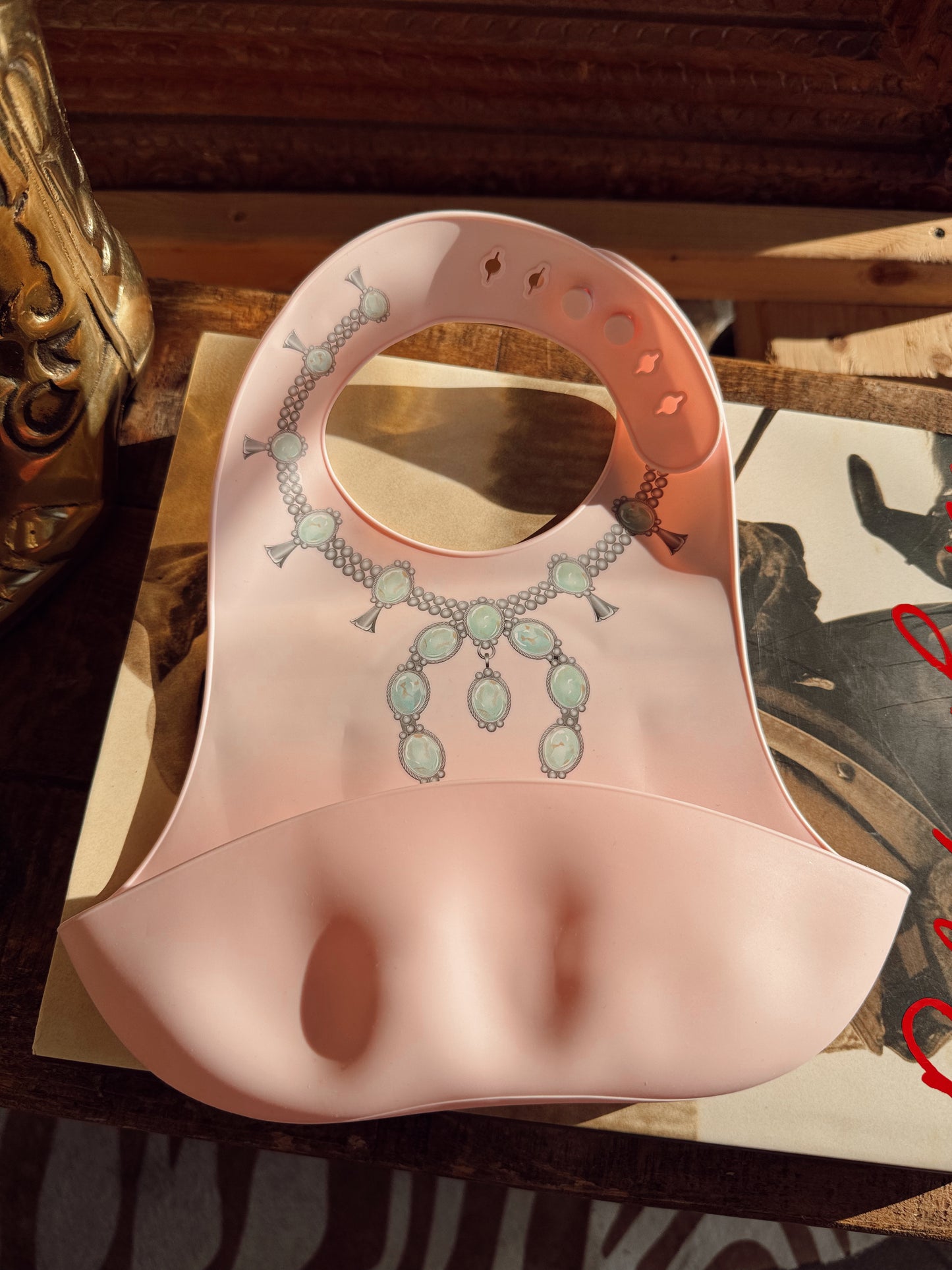 The Turquoise Squash Silicone Bib in Pink