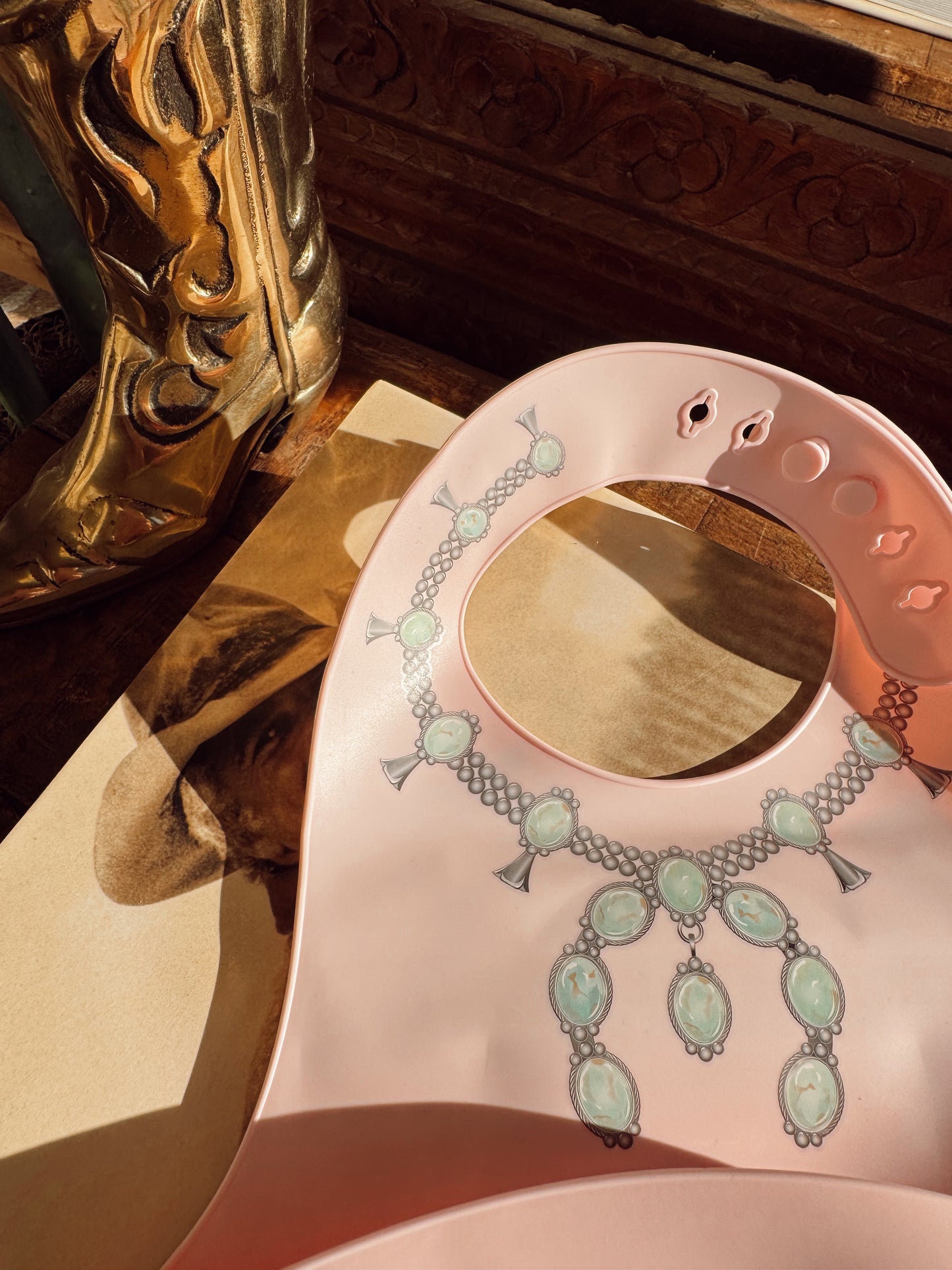 The Turquoise Squash Silicone Bib in Pink