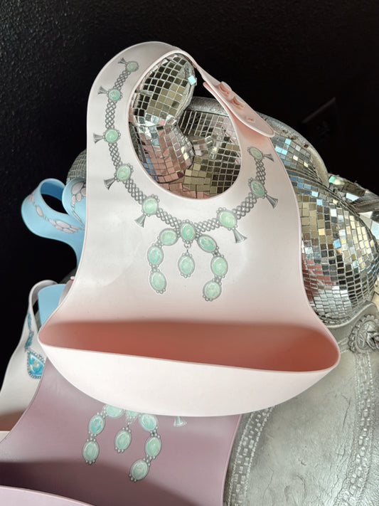 The Turquoise Squash Silicone Bib in Pink